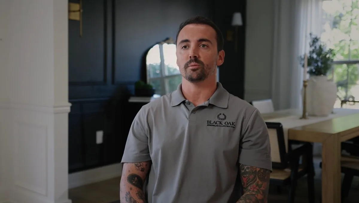 A Black Oak Remodeling and Construction team member in a company shirt, at home during a walkthrough.